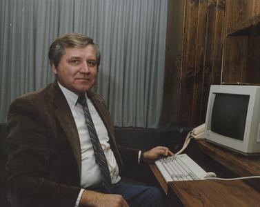 Harold Schlais at computer