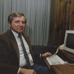 Harold Schlais at computer