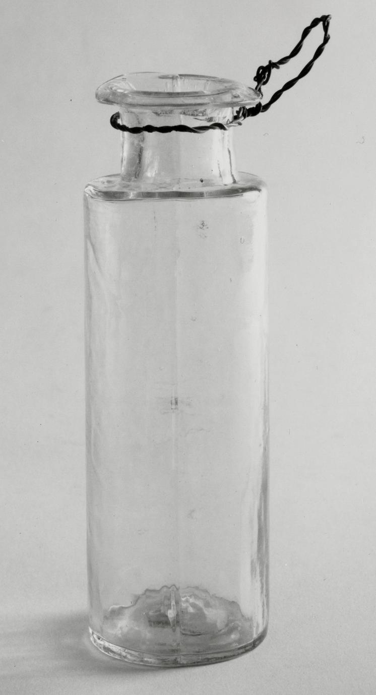 Black and white photograph of a vial.