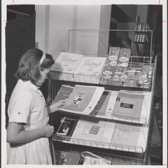 A young shopper examines school supplies from a drugstore display