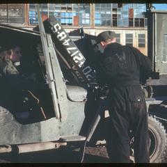 Karl, the German POW, repairing the jeep