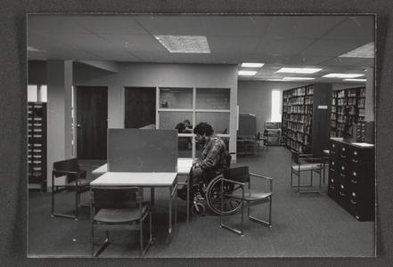 Students utilizing the library (at study table and in study room)