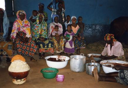 Group seated in shea butter workshop