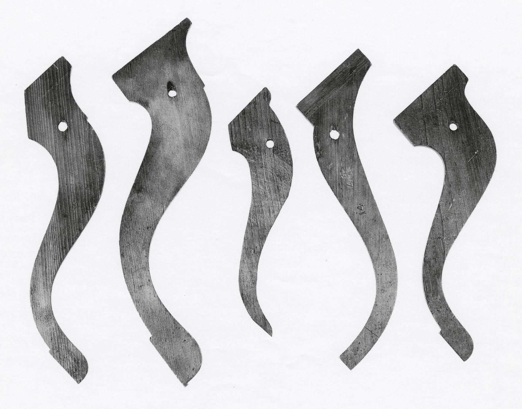 Black and white photograph of various candlestand and tea-table leg patterns.