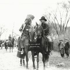 Two circus performers on horseback