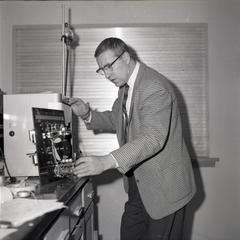Dr. Nathan Coward, with chemistry equipment