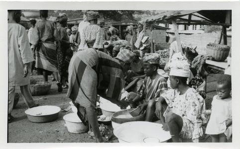 Woman buying gari at Oshu market