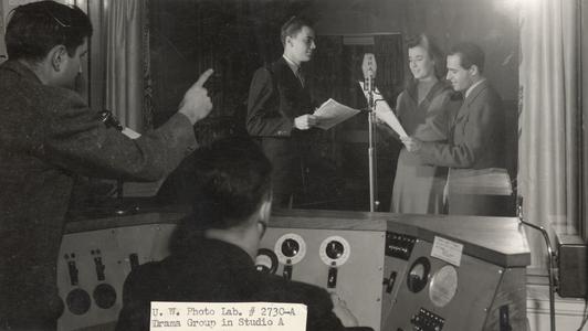 View from control room of radio players at microphone