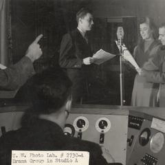 View from control room of radio players at microphone