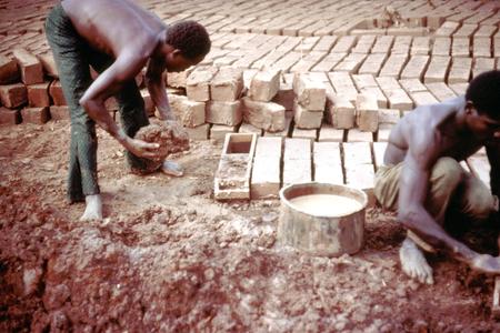 Packing Mud into Frames to Form Bricks