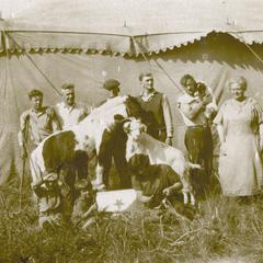 Circus performers posing with circus animals