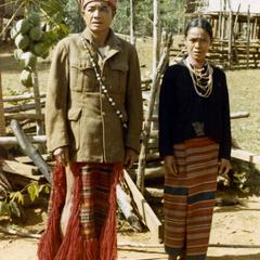 Nyaheun husband and wife stand in traditional clothing in Attapu Province