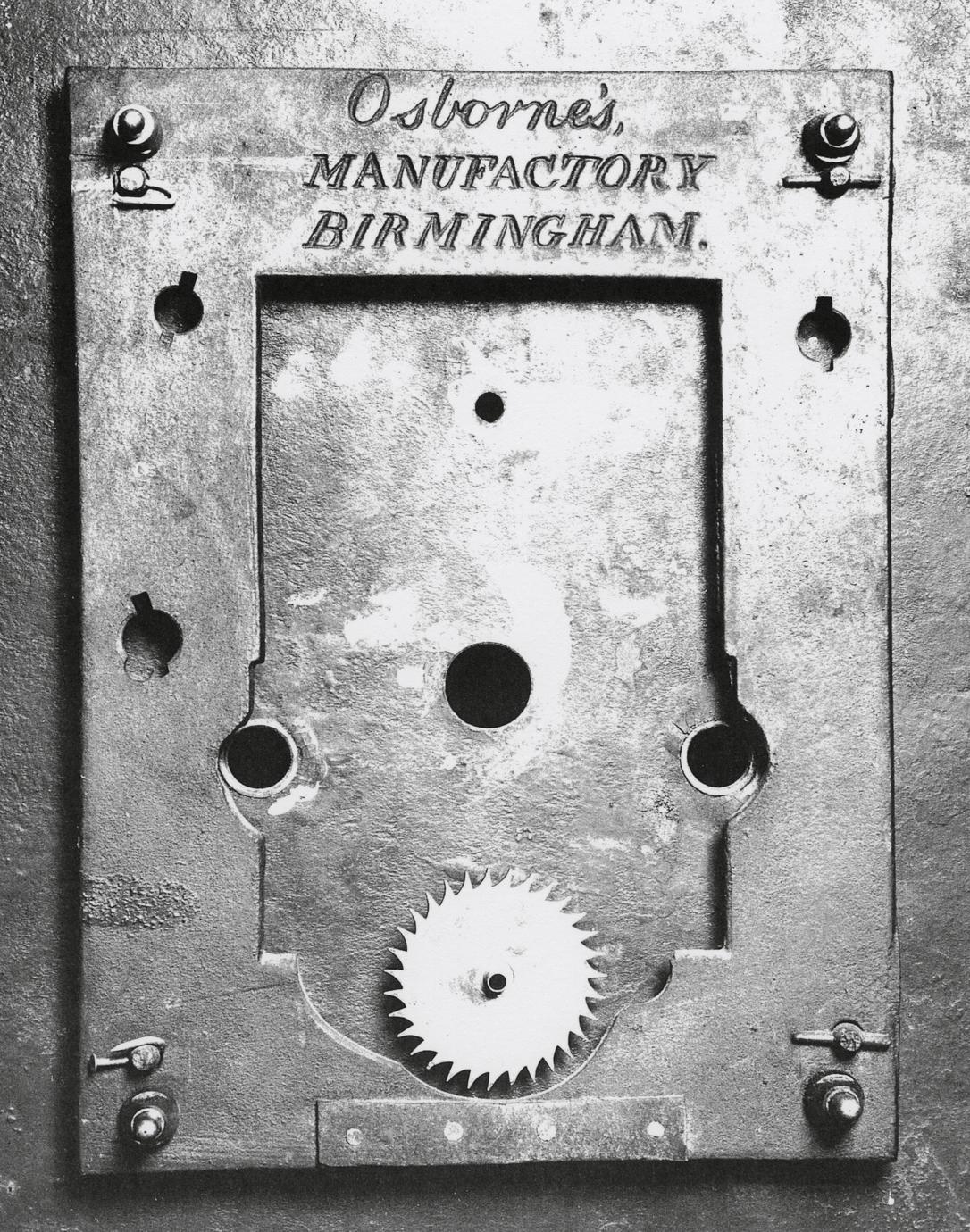 Black and white photograph of cast iron dial plate stamped "Osborne's MANUFACTORY BIRMINGHAM."