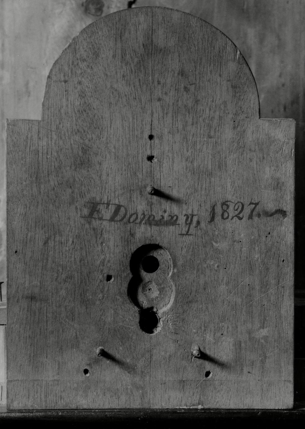 Black and white photograph of Felix Dominy's signature and date on a silent clock.