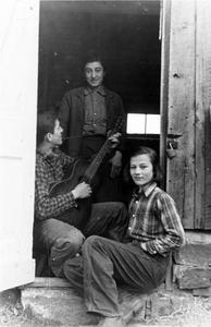 Estella Bergere Leopold, Carl, and Estella Jr. in shack doorway