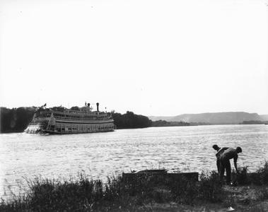 Sternwheel side view of the Capitol with bluffs in background