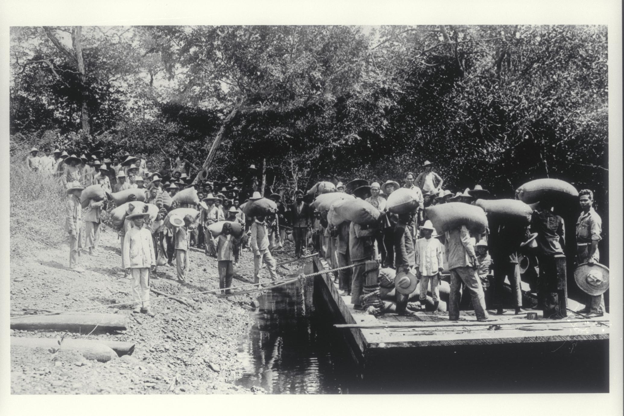 Hauling sacks to river, ca. 1920-1930