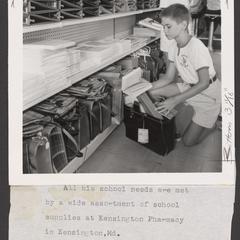 A young boy shops for school supplies