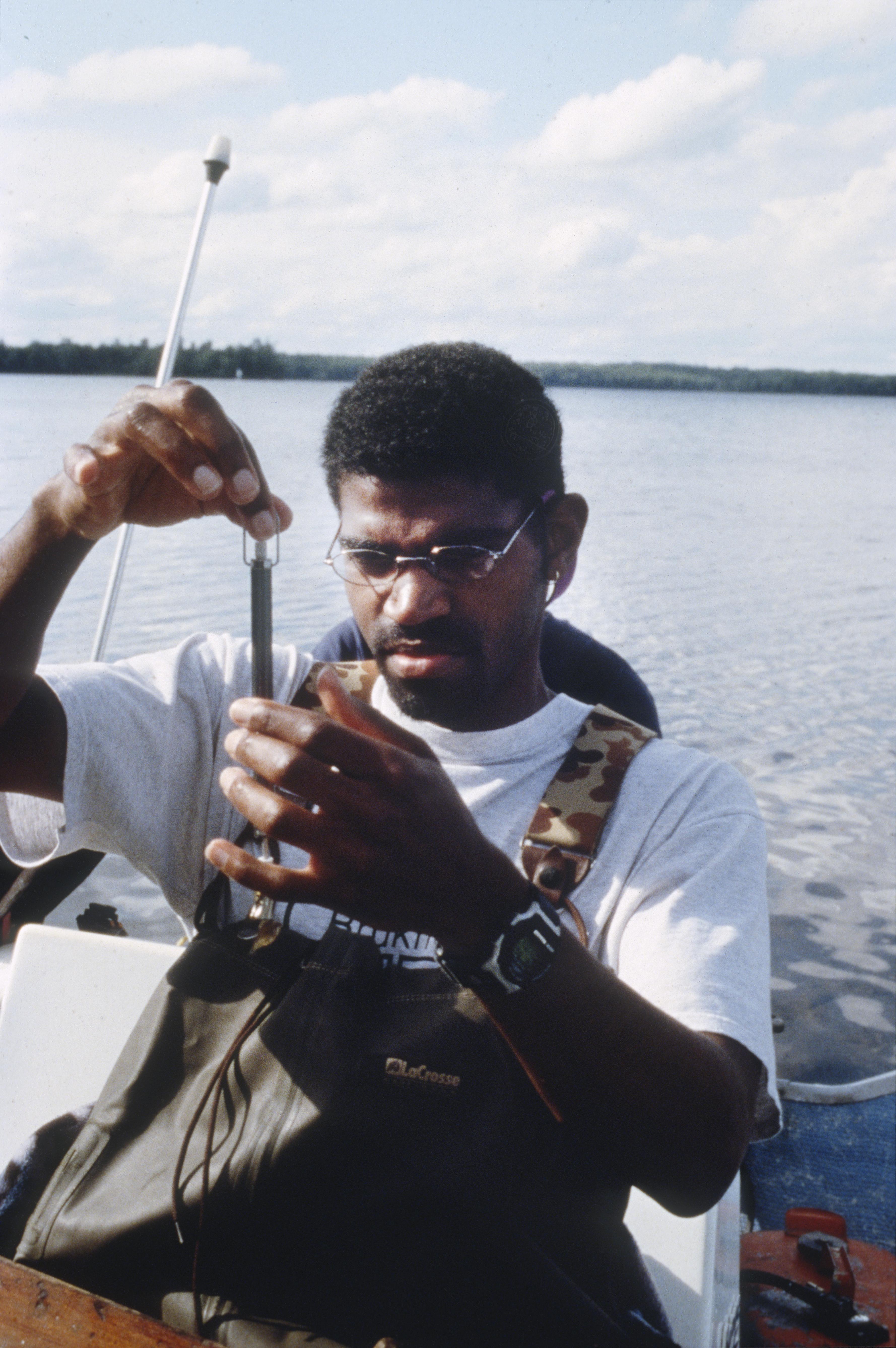 Theodore Willis weighing fish - UWDC - UW-Madison Libraries