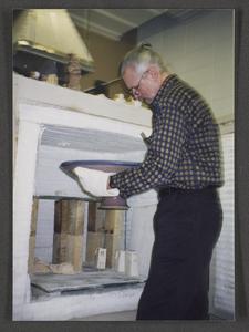 Professor Tom Gross (Art) taking a bowl out of a kiln