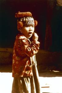 Yao (Iu Mien) child with needlework cap in Houa Khong Province