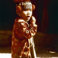 Yao (Iu Mien) child with needlework cap in Houa Khong Province