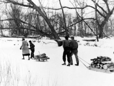 Aldo, Estella and grandchild hauling wood in the "Shack Slough," ca. 1938 (winter scene)