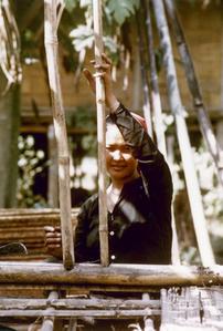 A Khmu' woman repairs a fence around her garden in Houa Khong Province