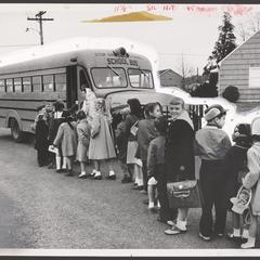 Children line up for a school bus