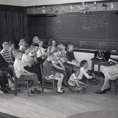 Schoolchildren listening to the radio