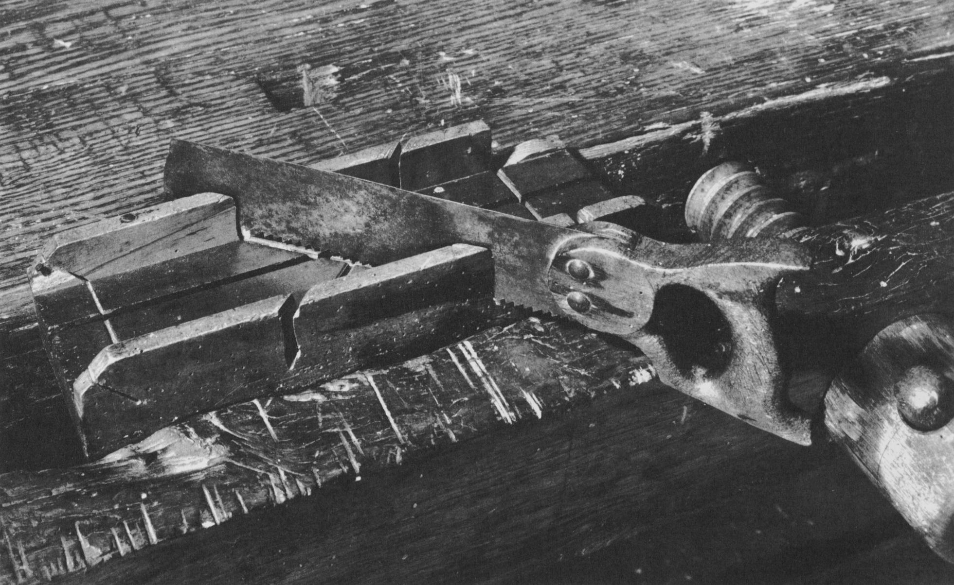 Black and white photo of a saw and miter box