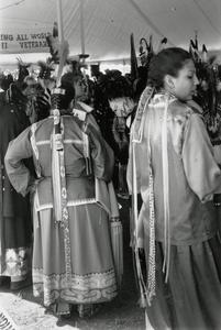 Young Ho-Chunk women in ribbon skirts and pah-kehs at powwow
