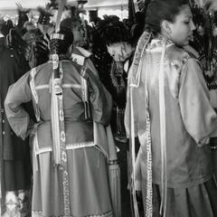 Young Ho-Chunk women in ribbon skirts and pah-kehs at powwow