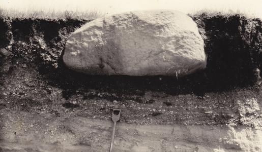 Large boulder in beach gravel