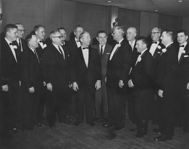 Group of men in tuxes or suits all standing