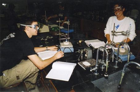 Two students enjoy their chemistry lab