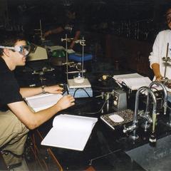 Two students enjoy their chemistry lab