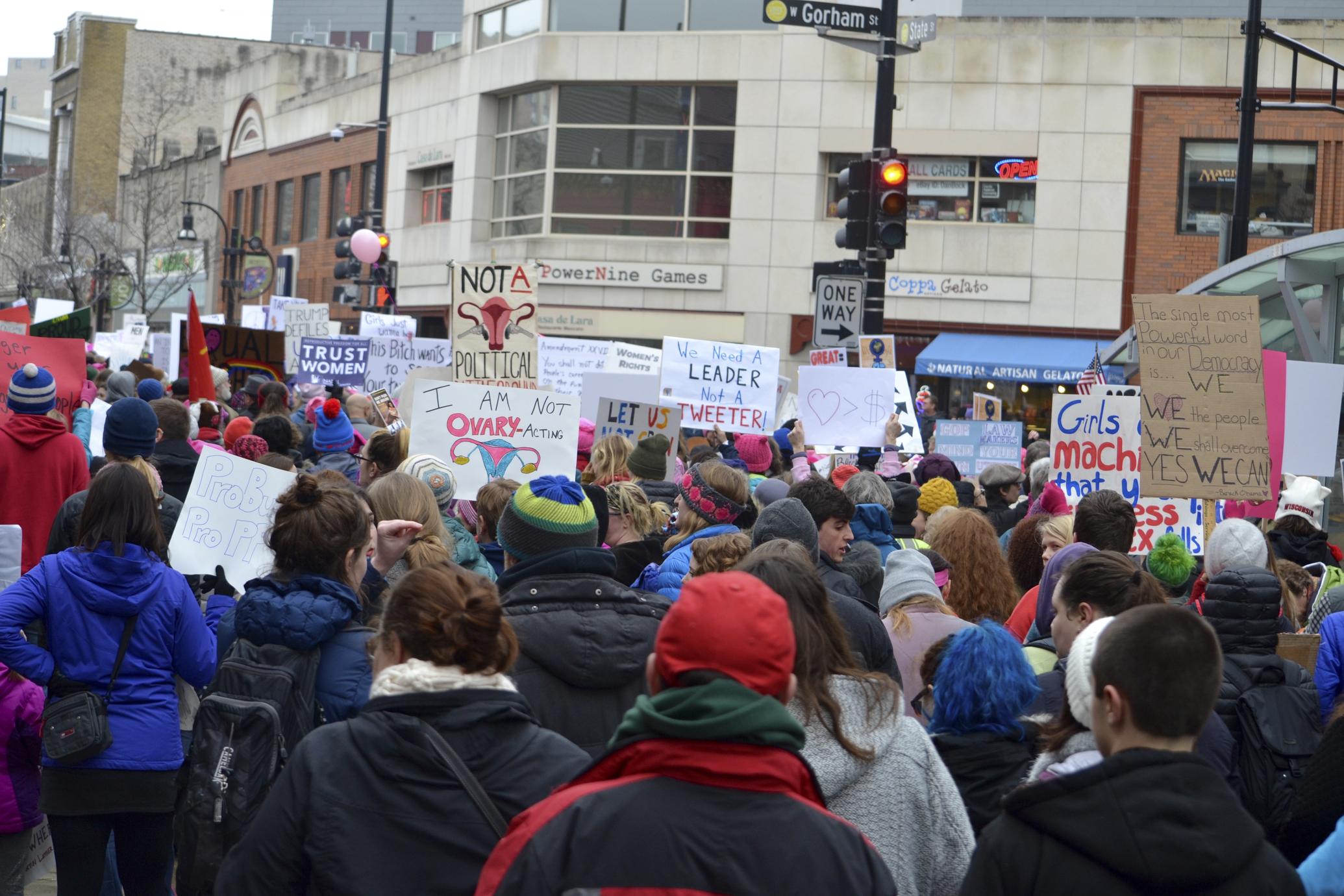 Sign-holding crowd marches up State Street