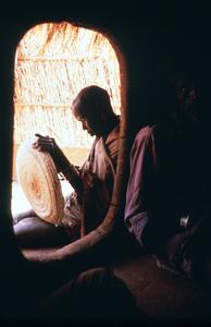 Man Weaving a Winnowing Basket in the Doorway