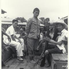 Guerrillas transporting a captured Japanese, Luzon, 1945