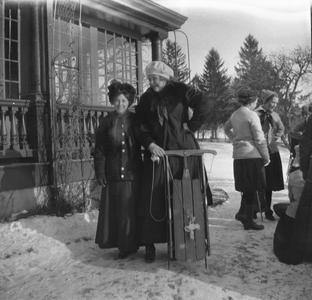 Women posing with sled