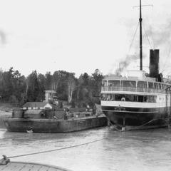 The Manitou aground in Saint Marys River with work barge