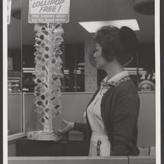 A woman examines a lollipop tree in a Walgreens drugstore