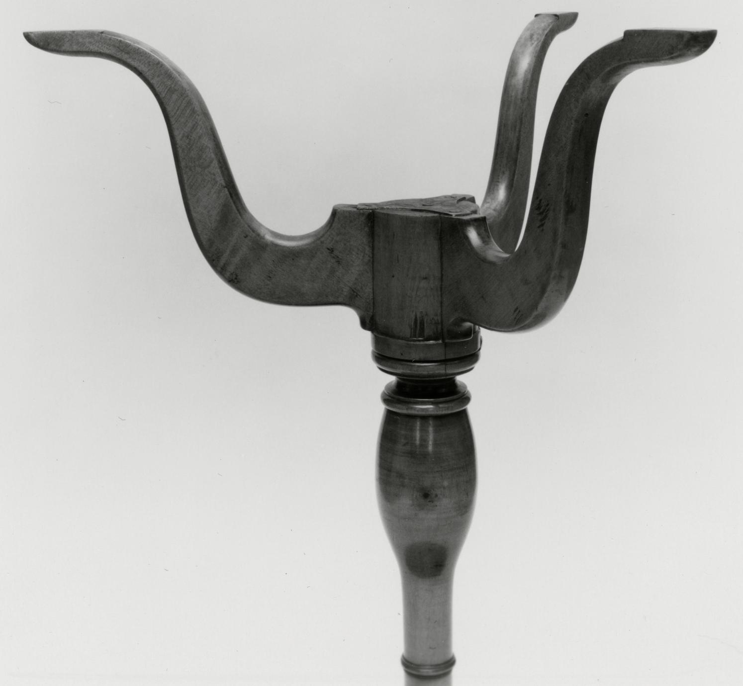 Black and white photograph of a stand's legs.