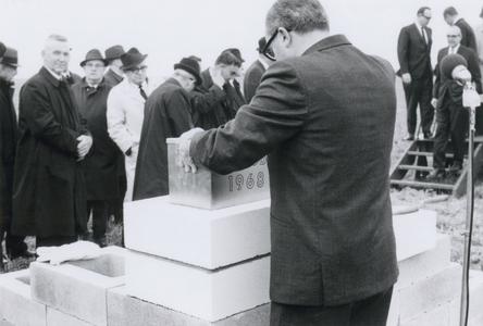 Cornerstone/time capsule being placed in the wall of the Environmental Sciences building