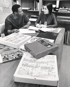 Bolarinde Obebe and Marylee Wiley in the Instruction Materials Center