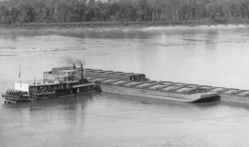 Aerial view of the S.S. Thorpe moving barges off sandbar