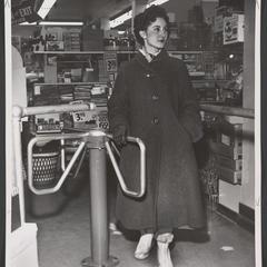 Woman walks through drugstore turnstile