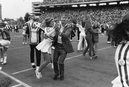 Elroy Hirsch and a cheerleader dancing a post game polka
