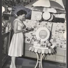 A woman looks at a display of summer cosmetics